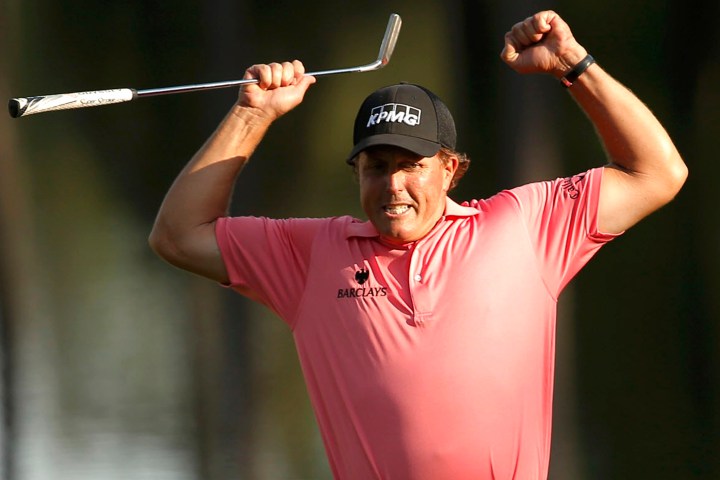 Phil Mickelson of the U.S. celebrates a long birdie putt on the 16th hole during third round play of the Masters golf tournament at the Augusta National Golf Course in Augusta